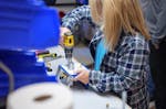 Ralston Instruments employee assembling a compressed gas volume controller by hand in a production area